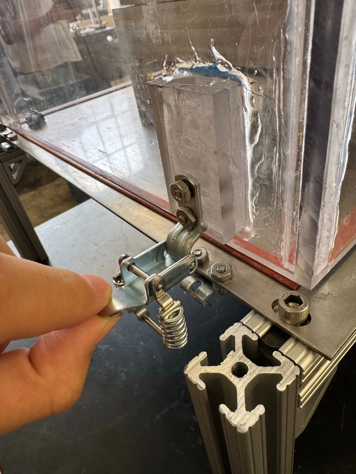 Adjustable draw latch and enclosure gasket detail.