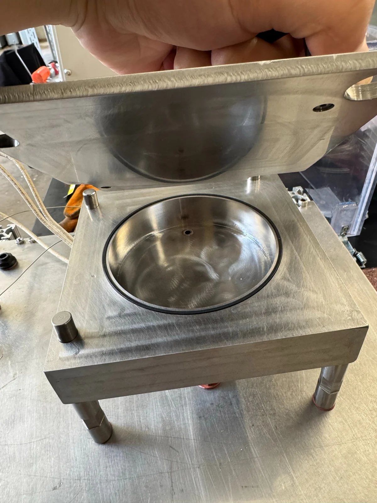 Open stainless-steel ALD reactor showing its chamber and O-ring seal